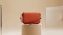 Coral crossbody bag shown as a demo catalog product